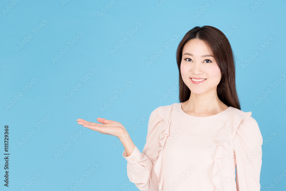 portrait of asian woman showing isolated on blue background