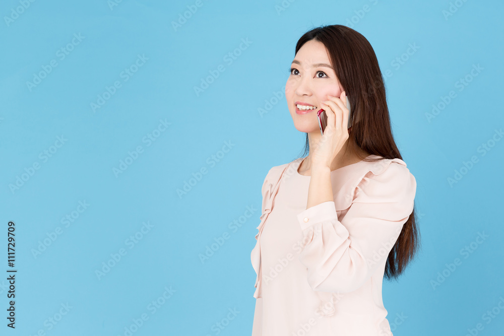 portrait of asian woman talking isolated on blue background portrait of asian woman talking isolated on blue background