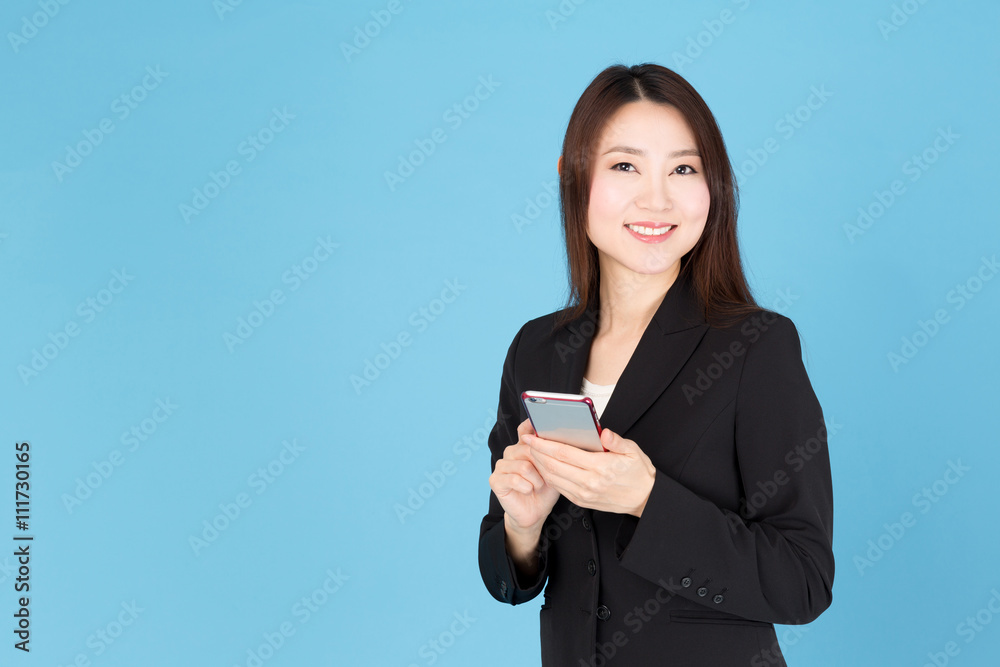 portrait of asian businesswoman using smart phone isolated on blue background portrait of asian businesswoman using smart phone isolated on blue background