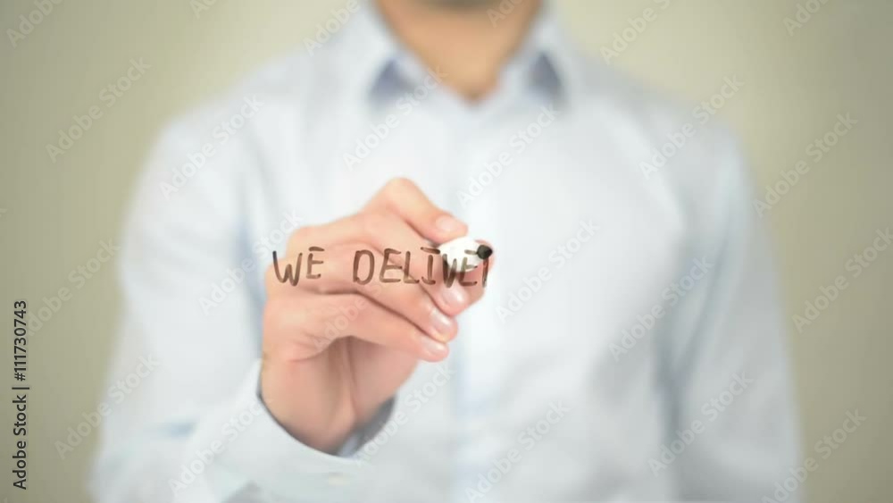 We Deliver Results, Man Writing on Transparent Screen We Deliver Results, Man Writing on Transparent Screen