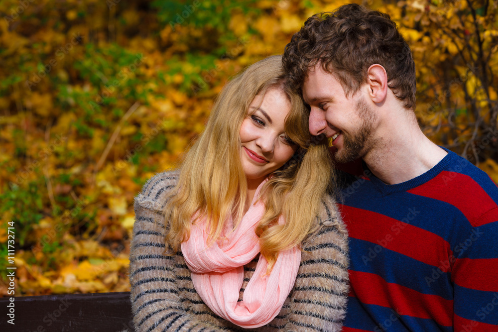 Lovers couple in autumn park on bench Lovers couple in autumn park on bench