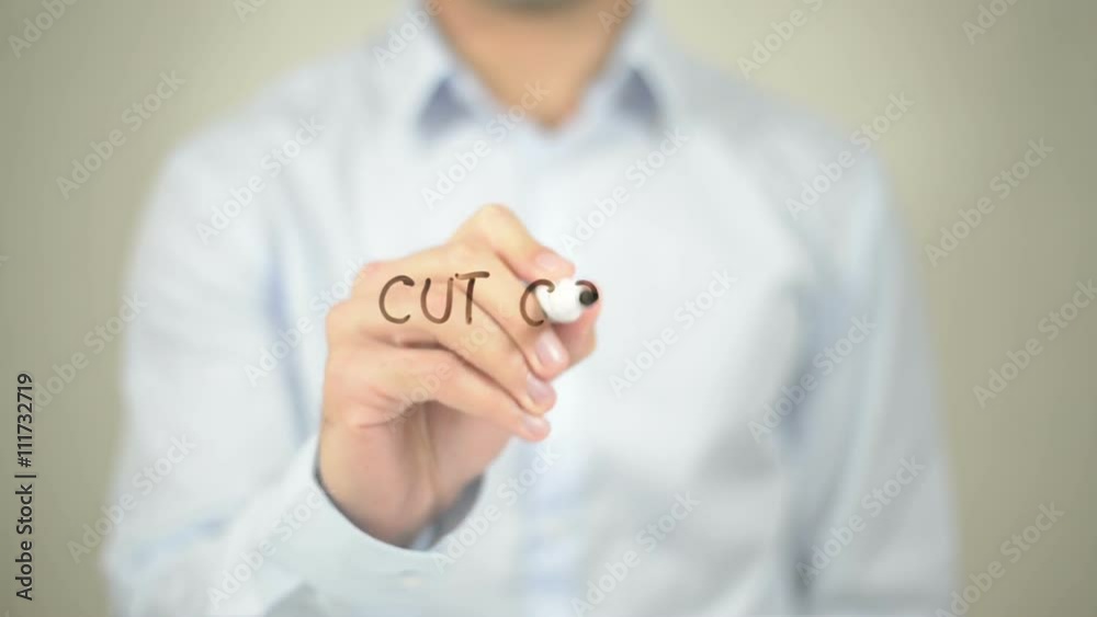 Cut Cost, Man writing on transparent screen Cut Cost, Man writing on transparent screen