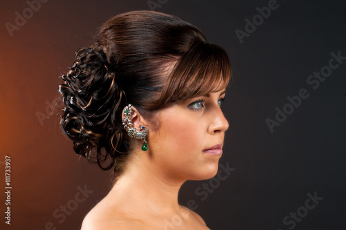 close-up shot of a young woman with elegant hairstyle.