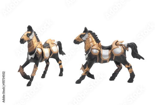 Isolated battle horse statue. Isolated battle horse toy in golden & steel armor outfit angle & profile view.