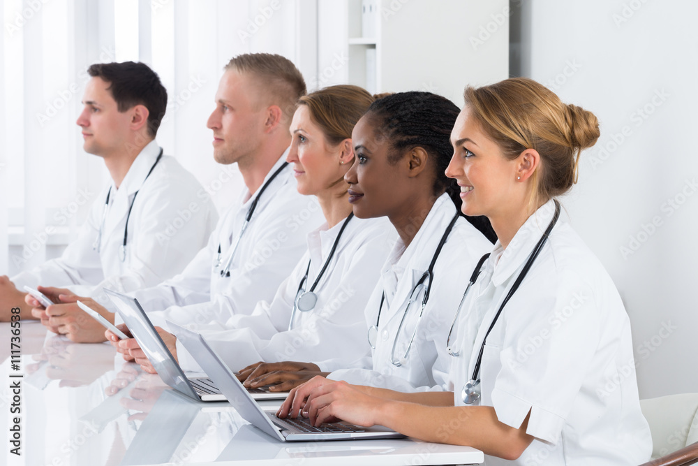 Doctors Using Laptop In Meeting Doctors Using Laptop In Meeting