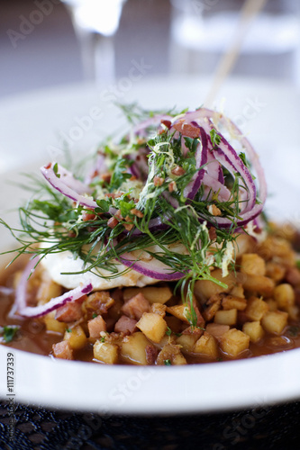 Hash of fried diced fish with onions and potatoes, close-up. photo