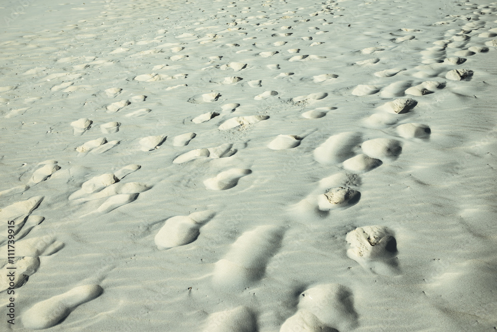 Footprints on the sand. Concept of life and travel Footprints on the sand. Concept of life and travel