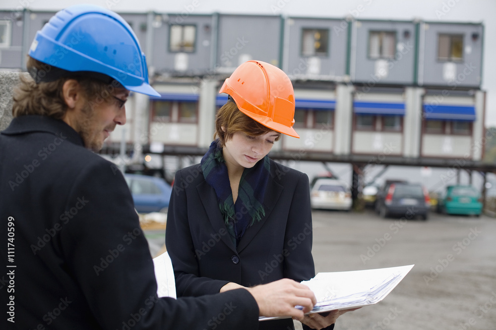 Project leaders at a building site, a man and a woman, Sweden. Project leaders at a building site, a man and a woman, Sweden.