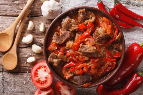 lamb cooked with onion, tomato and pepper closeup. horizontal top view
