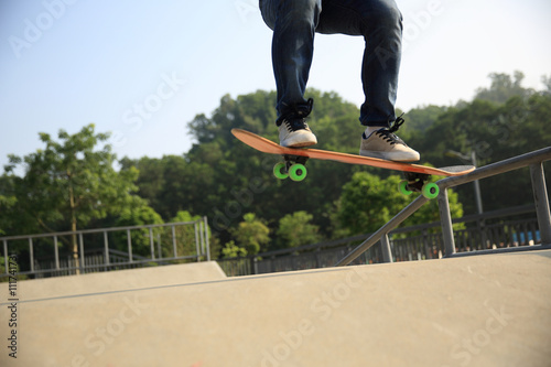 young woman skateboarder skateboarding at skatepark