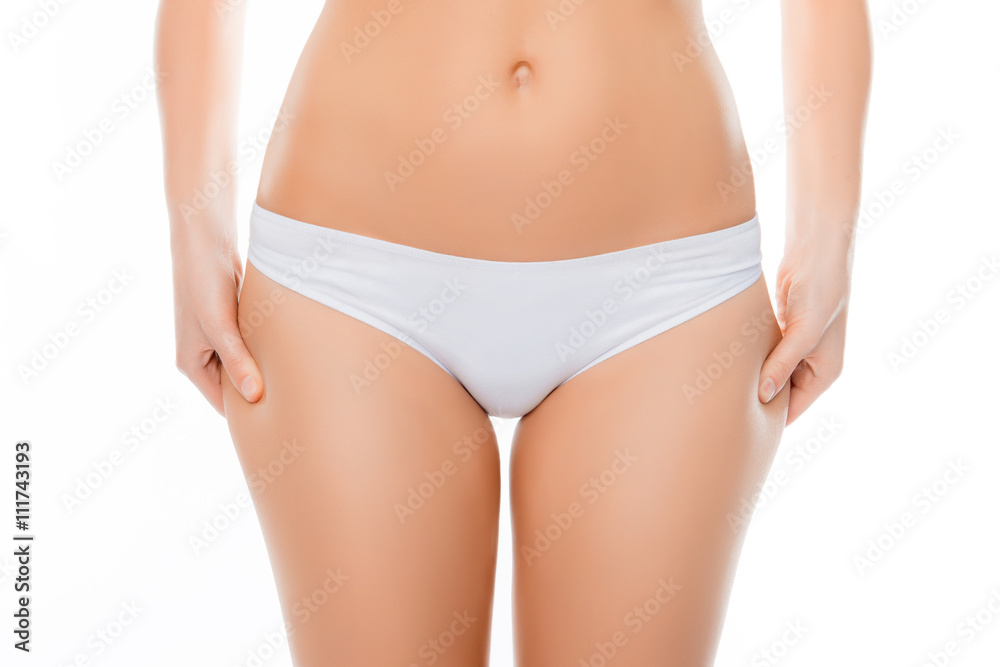 Close up portrait of fit woman checking fat on her hips