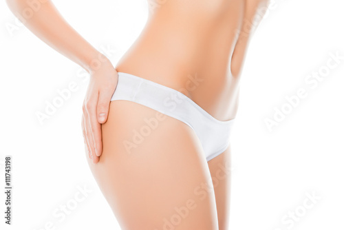 Close up portrait of shapely woman's body with hand on hip