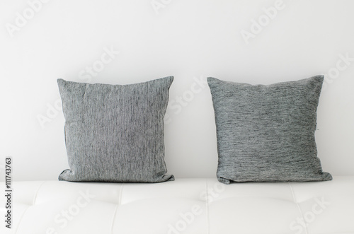 Fototapeta Naklejka Na Ścianę i Meble -  Black decorative pillows on a white casual sofa in the living ro