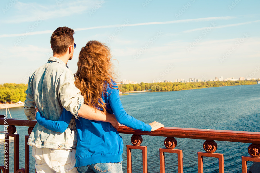 Happy young couple in love embracing each other on the bridge Happy young couple in love embracing each other on the bridge