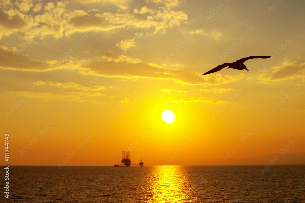 Sunset over an oil platform in the Aegean Sea