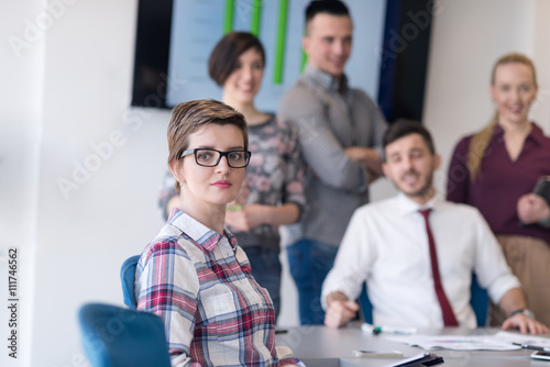 portrait of young business woman at office with team on meeting