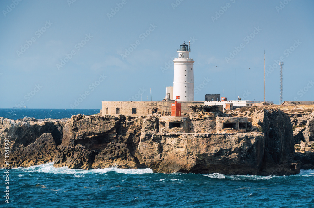 Sunny view of lighthouse of Tarifa port, Andalusia provice, Spain.