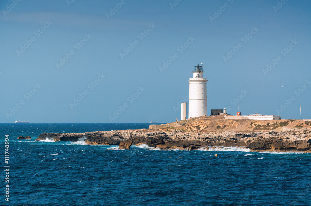 Sunny view of lighthouse of Tarifa port, Andalusia provice, Spain.