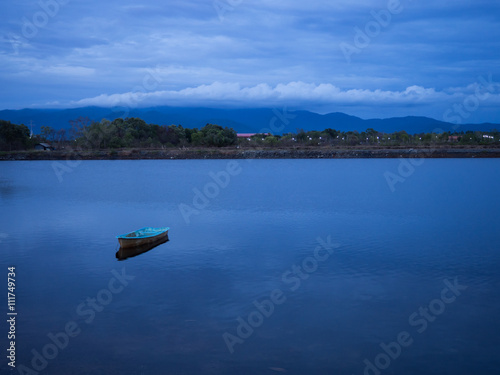 Fototapeta Naklejka Na Ścianę i Meble -  lonely boat lake with bluesky