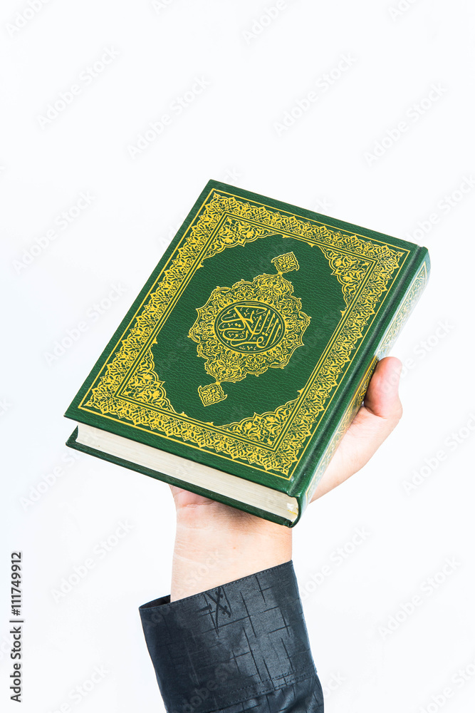 Koran in hand ,Quran in hand - holy book of Muslims , on white background Koran in hand ,Quran in hand - holy book of Muslims , on white background