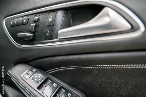 luxury car control buttons - door panel   Interior details.   © KissShot
