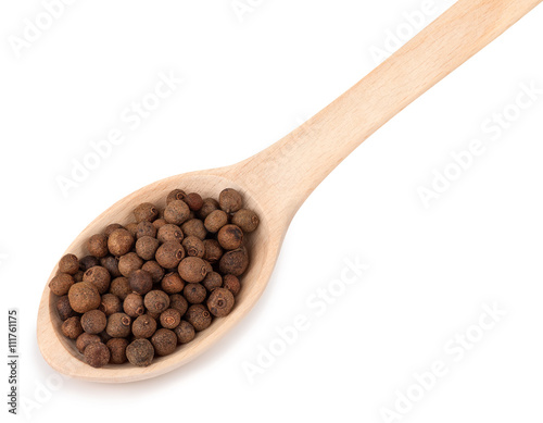 wooden spoon with allspice isolated on white background