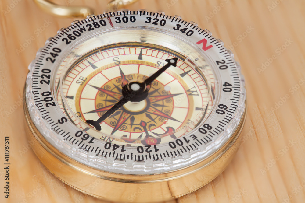 Classic Compass on a Wooden Table.