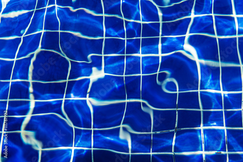 Water surface background at blue swimming pool