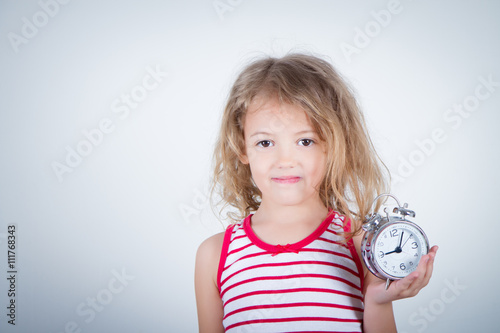 five-year-old girl with alarm clock