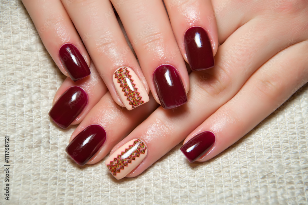 burgundy manicure with Ukrainian ornament on the ring finger burgundy manicure with Ukrainian ornament on the ring finger