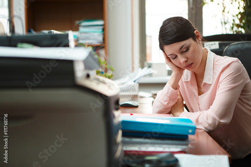 Картината върху платно Tired businesswoman sleeping on the desk.