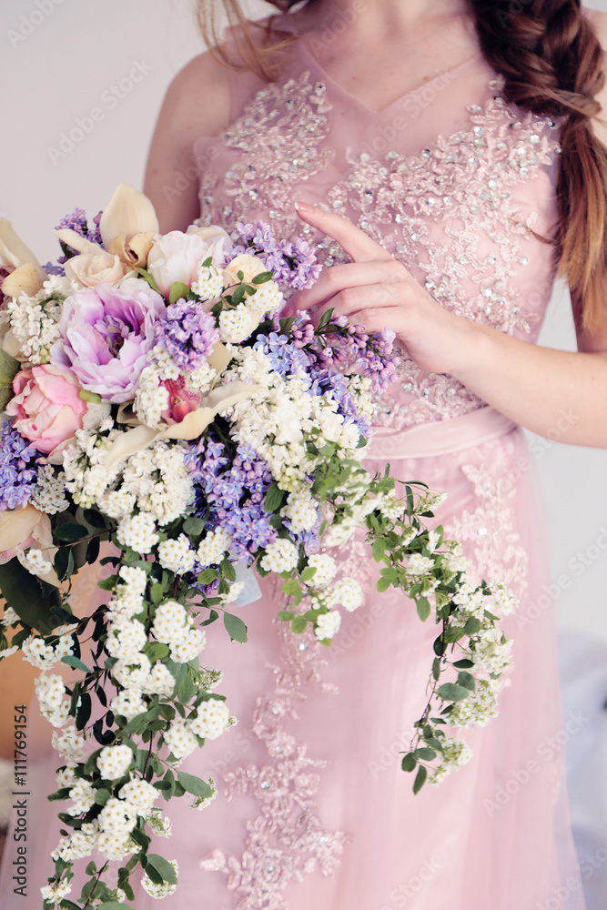fashion studio photo of gorgeous young woman with dark hair in elegant dress posing with spring flowers fashion studio photo of gorgeous young woman with dark hair in elegant dress posing with spring flowers