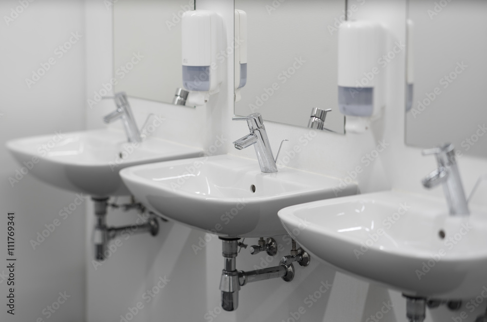White washbasins in the bathroom. Toilet, WC. White washbasins in the bathroom. Toilet, WC.
