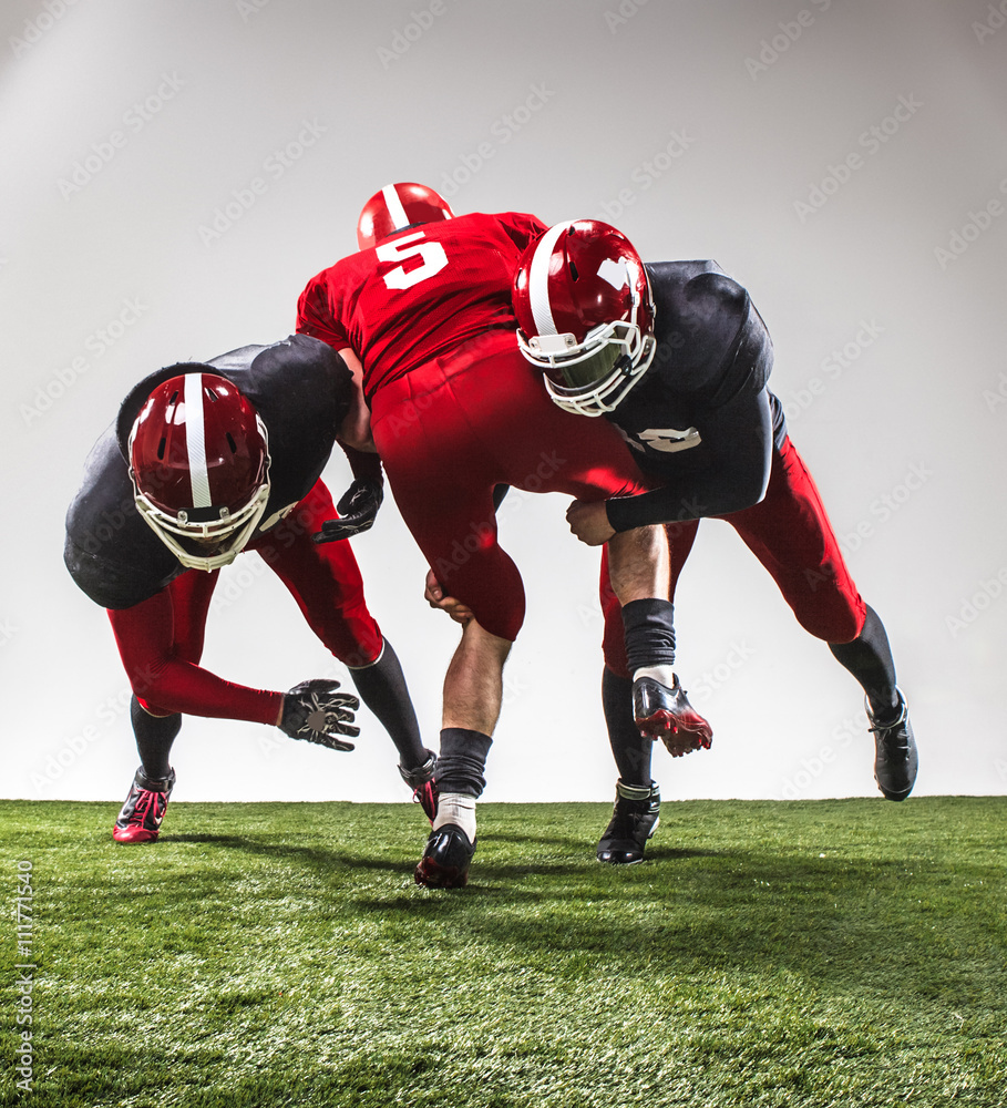 The three american football players in action The three american football players in action
