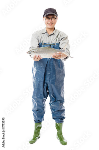 Obraz na plátne happy fisherman showing big fish isolated on white