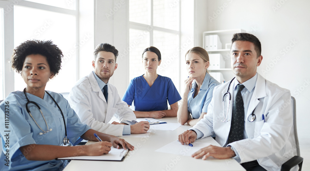 group of happy doctors meeting at hospital office group of happy doctors meeting at hospital office