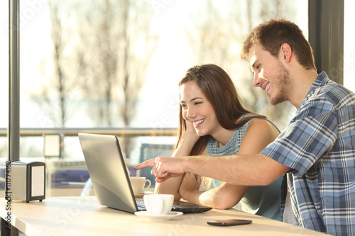 Couple searching information in a laptop photo