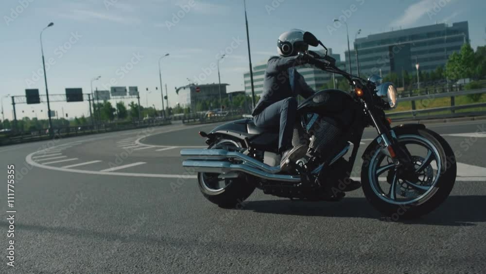 Business man riding a motorcycle in a city Business man riding a motorcycle in a city
