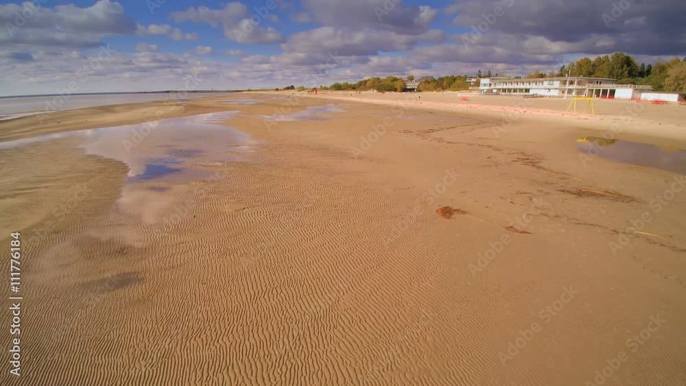 Aerial view of the sandy shore in low tide. Taken during a low tide in Parnu beach where the shoreline is so wide Aerial view of the sandy shore in low tide. Taken during a low tide in Parnu beach where the shoreline is so wide