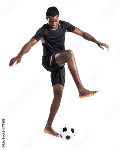 Fototapeta Naklejka Na Ścianę i Meble -  Black man playing football
