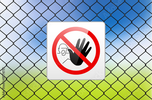 Metal sign RESTRICTED AREA - NO ENTRY on metal fence