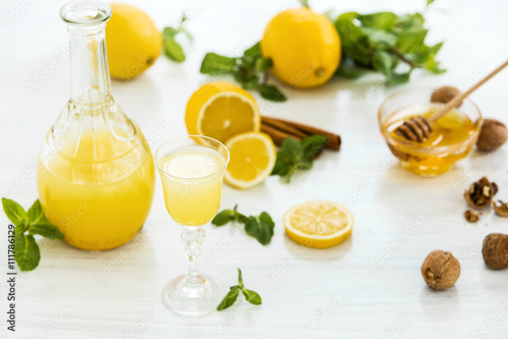 Italian traditional liqueur limoncello with lemon Italian traditional liqueur limoncello with lemon