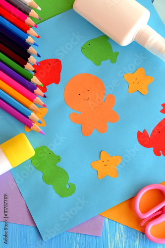 Preschool sea animals arts and crafts. Paper ocean animals. Kindergarten. Early childhood education. Pencils, glue, scissors, colored paper. Kids background