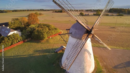 Closer look of the old propellers of the windmill found near the house in the middle of the field photo