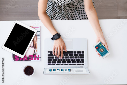Pleasant woman sitting at the table 