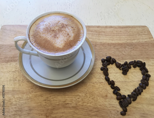 Coffee cup and heart from roasted coffee beans © Elya.Q