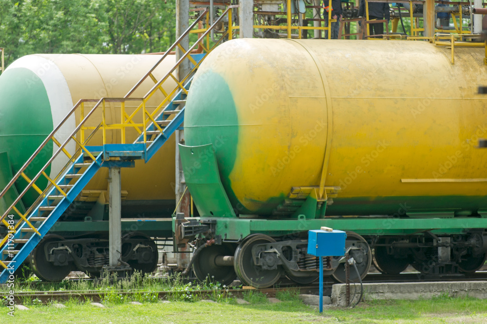 Old fuel tanks at the oil terminal on railway station on a summer day Old fuel tanks at the oil terminal on railway station on a summer day
