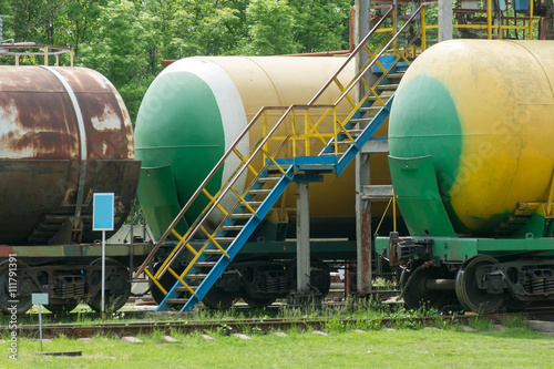 Old fuel tanks at the oil terminal on railway station on a summer day