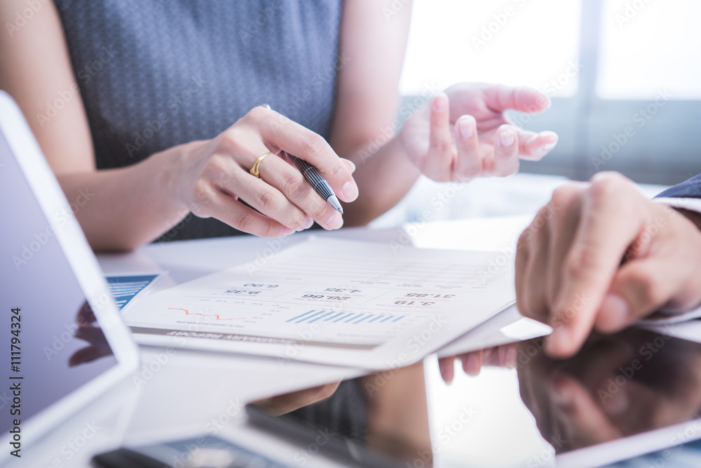 Image of business partners discussing documents and ideas at mee Image of business partners discussing documents and ideas at mee