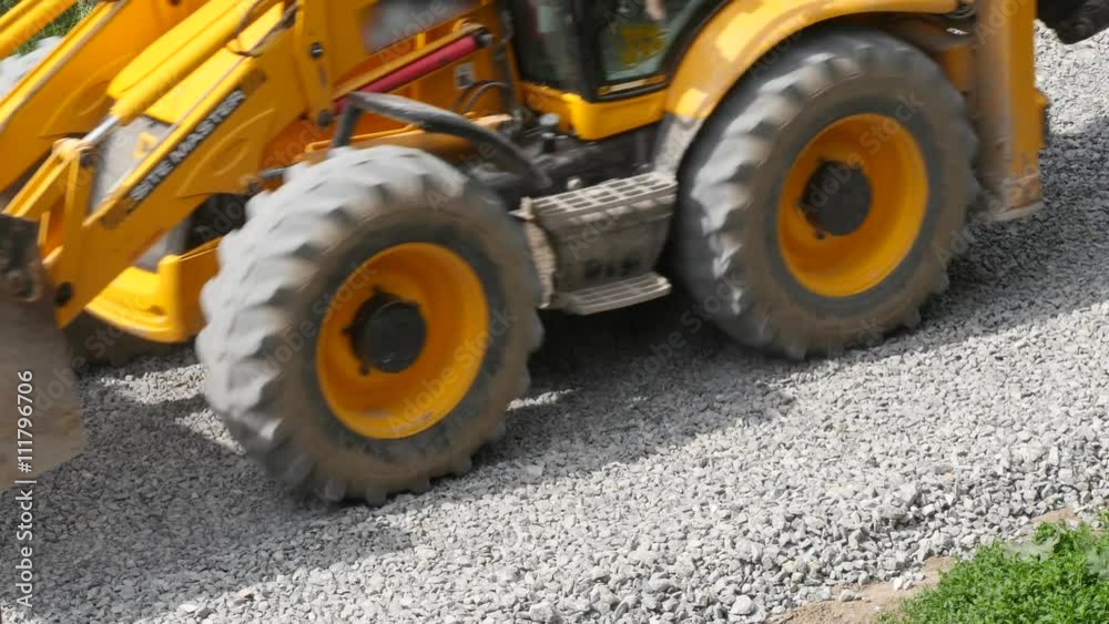 Excavator carries gravel in the bucket on road construction Excavator carries gravel in the bucket on road construction